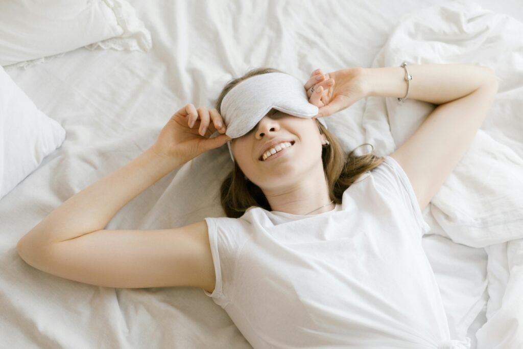 pexels photo 6603663 6603663 A serene young woman enjoying relaxation with a sleep mask in her cozy bed.
